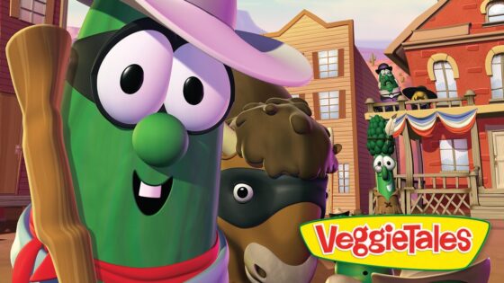 Three cheerful cartoon vegetables in a Western town with a colorful VeggieTales logo in the foreground.