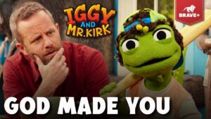 Bearded man in a red shirt and a green puppet holding a wooden bat, both looking thoughtful; bold 'GOD MADE YOU' text overlays the thumbnail.