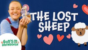 Smiling woman holds a plush sheep beside bold 'THE LOST SHEEP' text, hearts, a cartoon sheep, and the God's Greenhouse logo on a blue background.